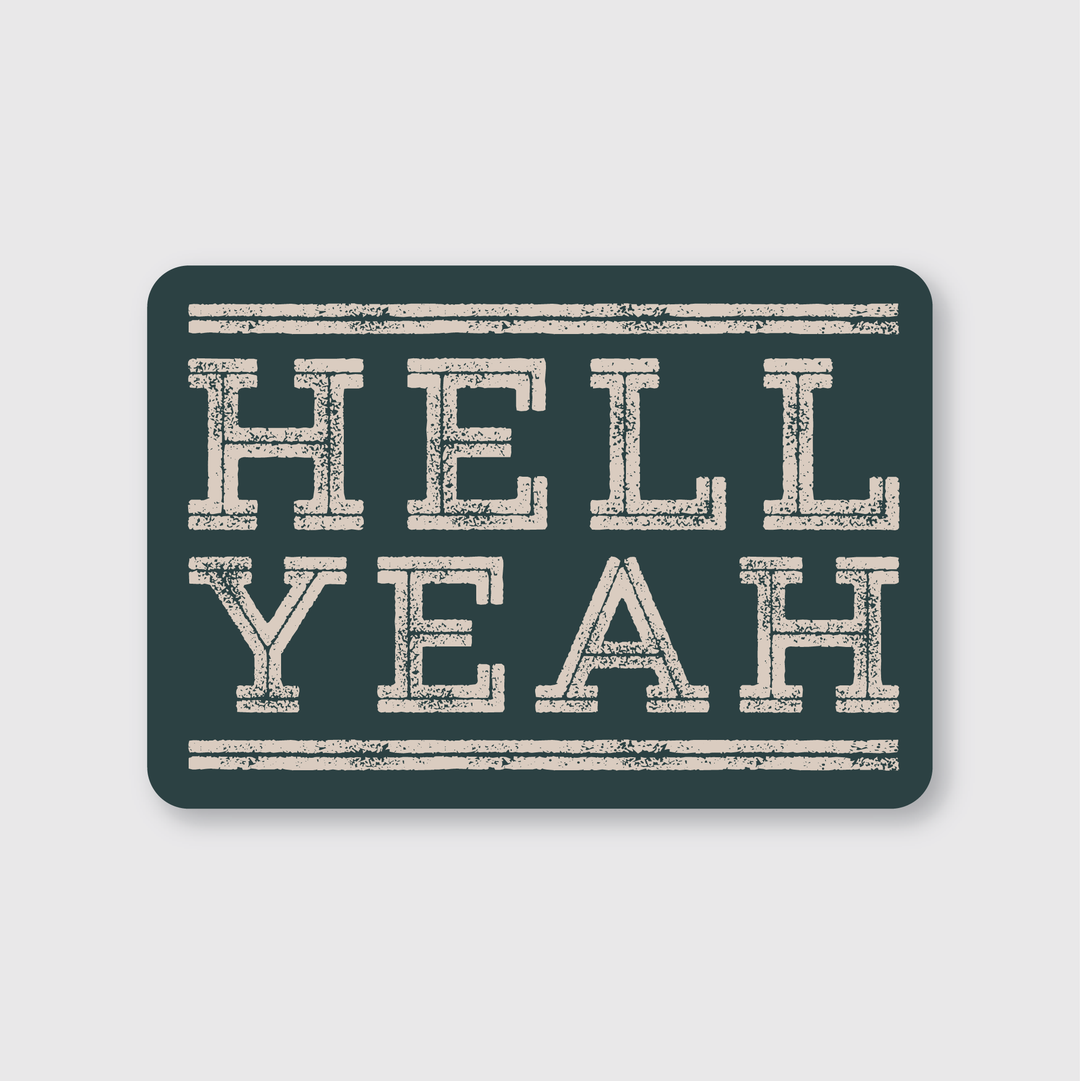 The Hell Yea Sticker features a rectangular design in dark teal with bold, distressed white "HELL YEAH" text centered between two thin white lines. Crafted as a die-cut vinyl sticker, it is water and weather-resistant, offering enduring durability and style from its handcrafted origins in Seattle.