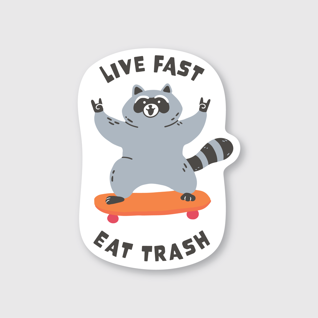 The description beautifully captures the essence of the "Live Fast Eat Trash" sticker. It features a cartoon raccoon doing rock-and-roll hand signs while skating on an orange skateboard. The die-cut vinyl sticker is designed to be both water and weather resistant. Bold text above and below the raccoon enhances its rebellious vibe, all set against a clean white background.
