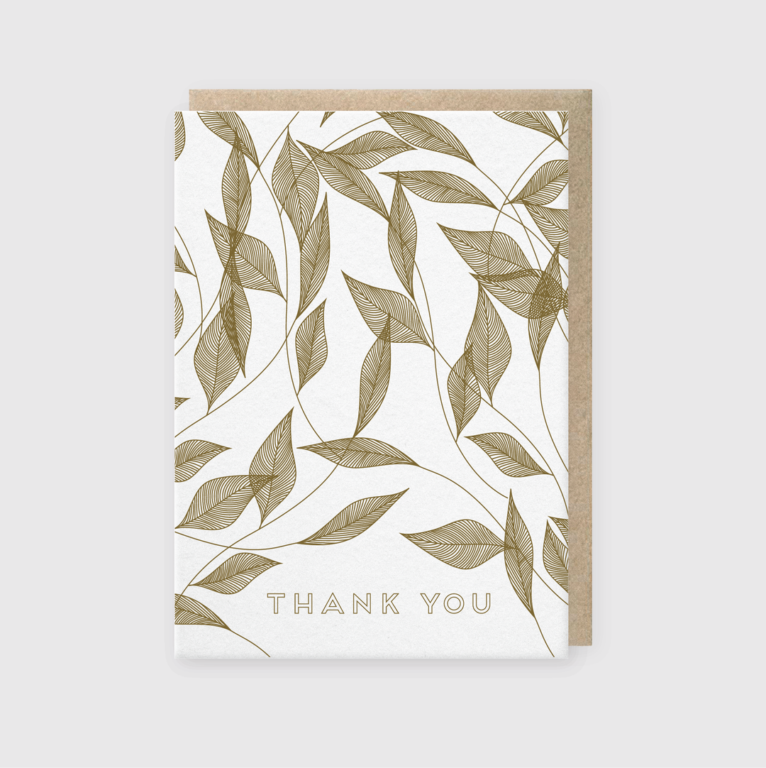 Introducing a handcrafted greeting card featuring a delicate gold leaf and vine leaves design on a pristine white background. The phrase "THANK YOU" is elegantly printed in gold at the bottom, highlighted against a subtle light gray backdrop.