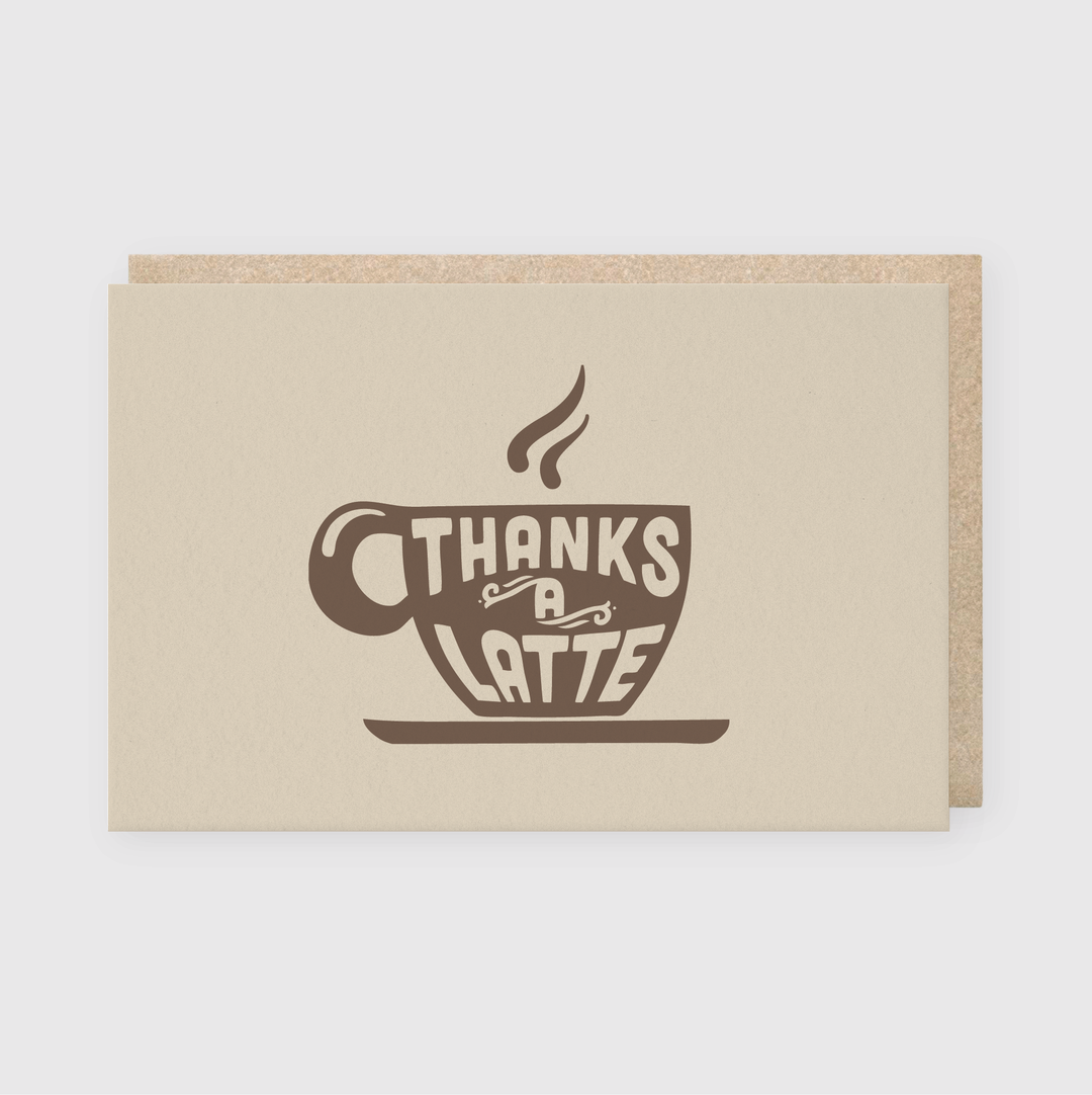 The "Thanks a Latte" Kraft Greeting Card is a perfect option for coffee lovers. It features an illustration of a steaming coffee cup with the playful phrase "Thanks a Latte." Made from light brown paper, this handcrafted card includes a matching envelope.