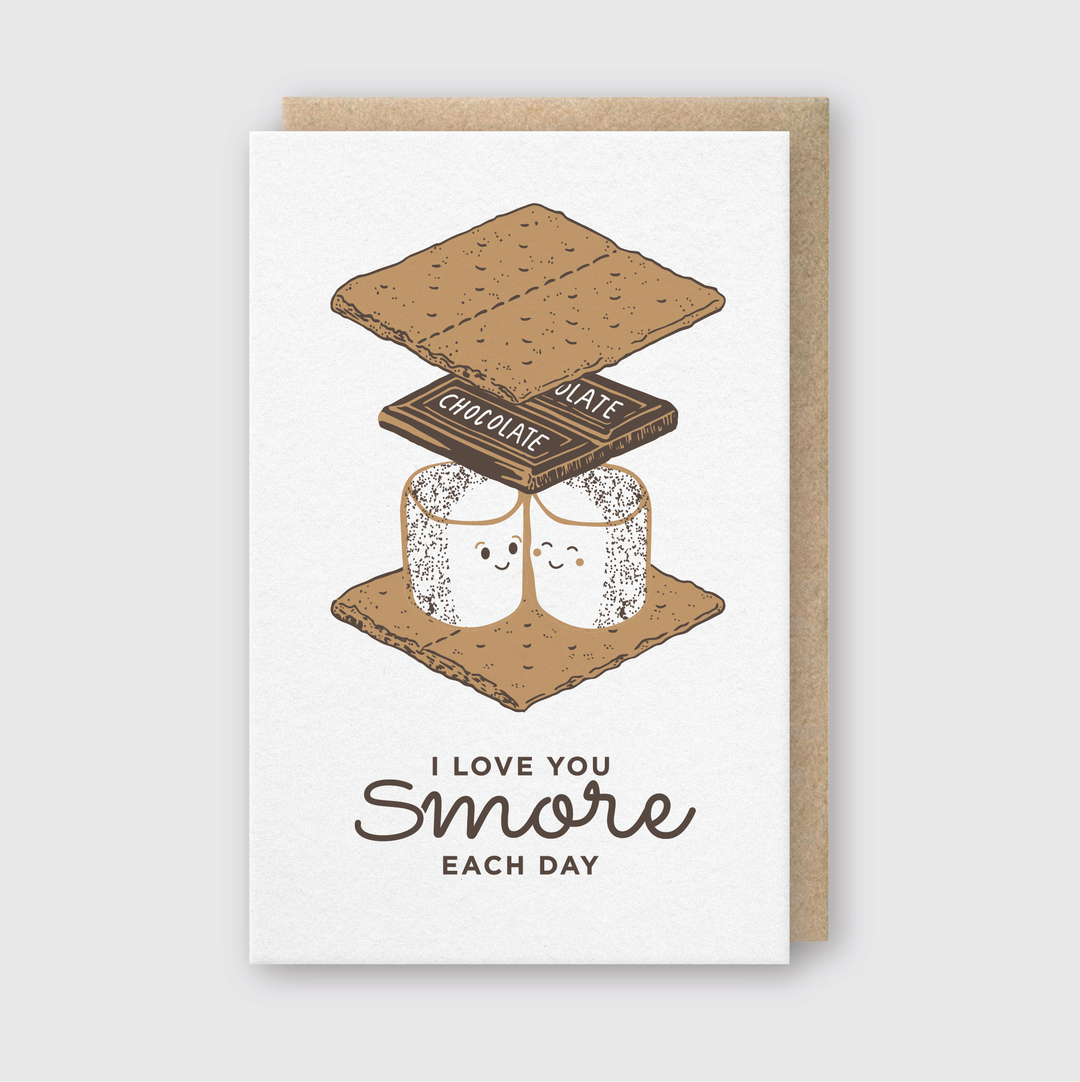 Here is a description of the "Love you S'mores Greeting Card" featuring two cheerful marshmallows sandwiched between chocolate and graham crackers. The card includes the message, "I love you s'more each day," and comes with a recycled Kraft envelope. It is hand-printed in Seattle.