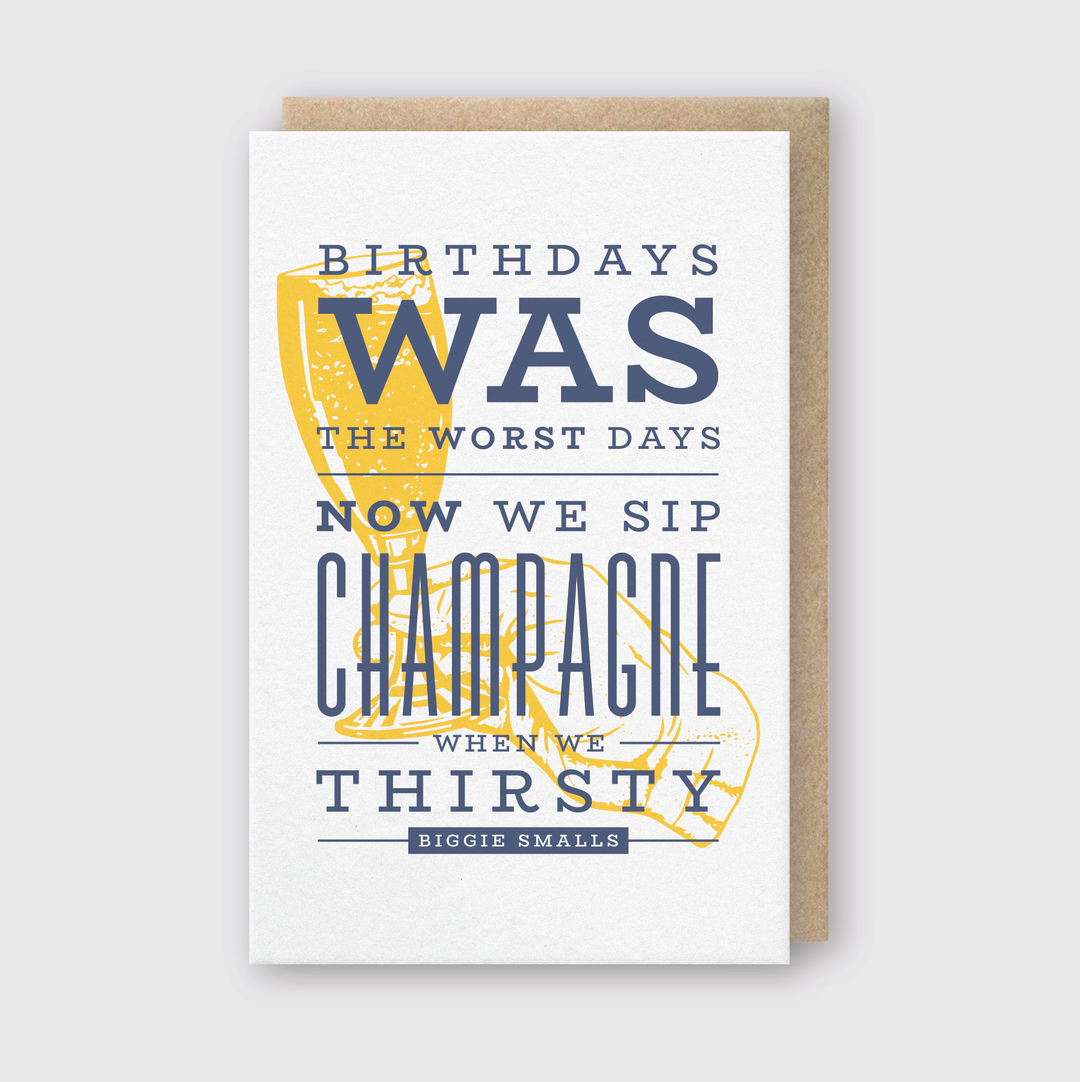 The Sip Champagne On Birthday Greeting Card features a champagne glass illustration paired with a famous quote in vibrant blue and yellow typography. It comes with a recycled Kraft envelope, adding an eco-friendly element to your celebration. Crafted in Seattle by Pike Street Press, this card combines artistic design with sustainable materials for a thoughtful birthday greeting.