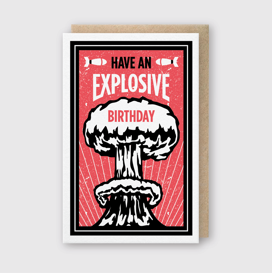 This handcrafted birthday greeting card features a striking red and black design with a mushroom cloud illustration. Printed using traditional letterpress techniques, it delivers the playful message "Have an Explosive Birthday." The card is embellished with small bomb graphics flanking the word "Explosive," adding to its unique and creative appeal.