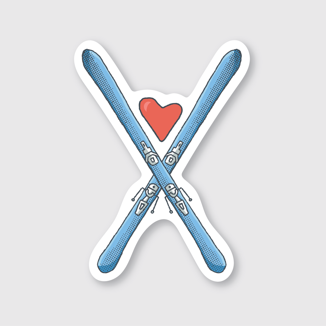 The Heart Skis Sticker features an illustration of two crossed blue skis with a red heart above them on a light gray background, making it the perfect choice for skiing enthusiasts. This high-quality die-cut vinyl sticker allows you to showcase your love for the slopes.