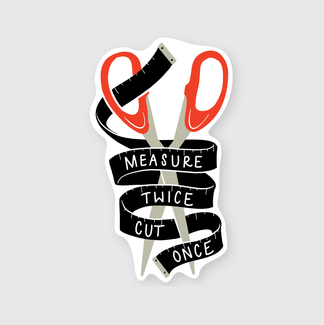 The "Measure Twice Sticker" is a thoughtfully designed vinyl sticker showcasing a pair of red scissors creatively intertwined with a black measuring tape. The tape is adorned with the classic phrase "Measure Twice Cut Once" in crisp white text set against a light grey backdrop. This design combines functionality with aesthetics, offering both durability and visual appeal as it's made to withstand various weather conditions.
