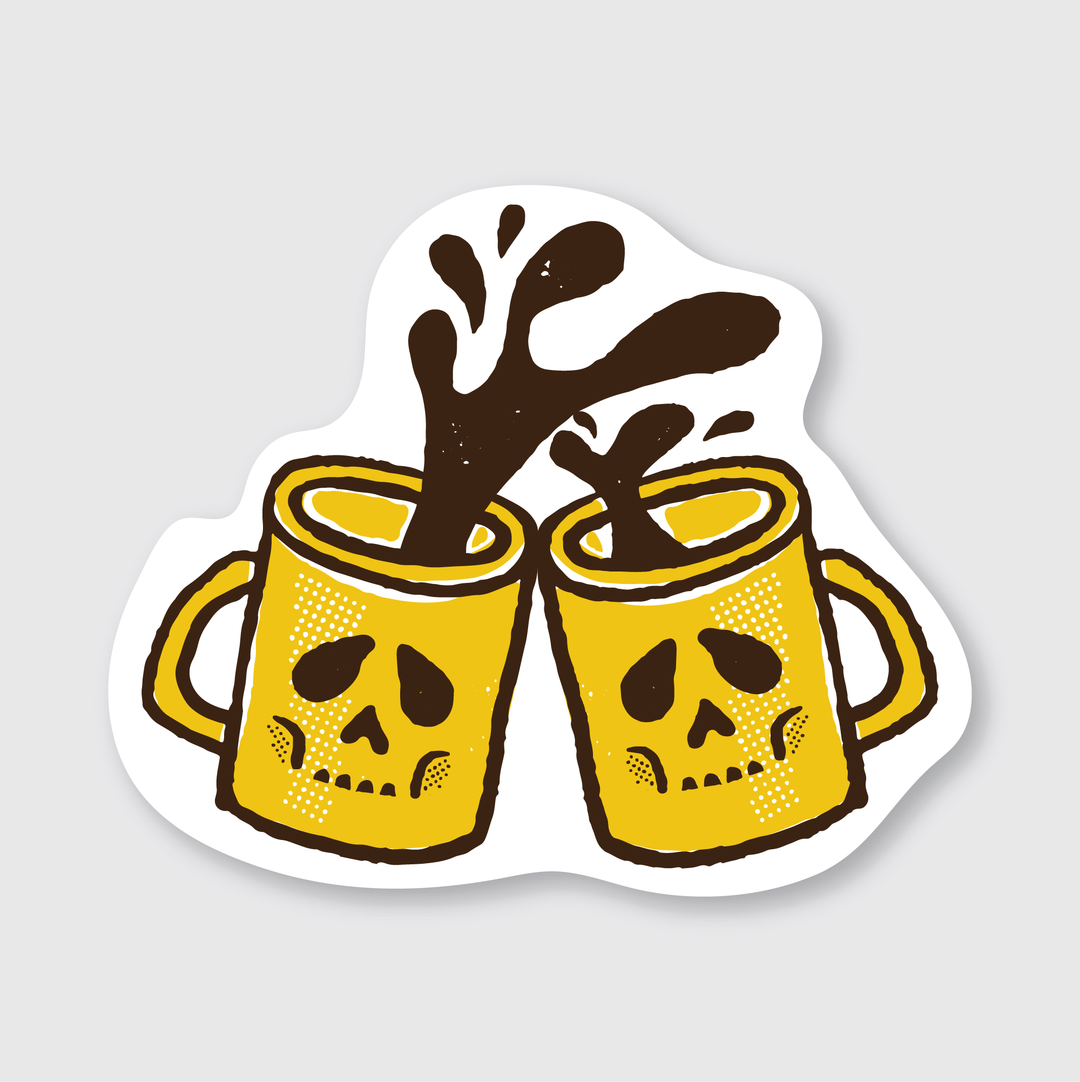 An illustration depicts two yellow coffee cups, each adorned with skull faces, clinking together to celebrate a shared moment. Dark liquid brims within the cups, capturing a dynamic splash as they meet. This whimsical design offers a perfect way for coffee lovers to express their passion through a unique vinyl sticker, ideal for personalizing various items and adding an edgy touch.