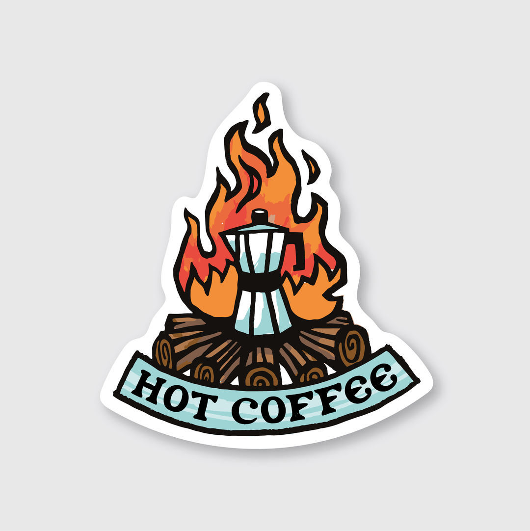 The illustration features a whimsical design with a coffee maker perched on logs that are encircled by flames. Beneath this scene, a banner reads "Hot Coffee." The overall artwork has a playful and adventurous feel, making it perfect for outdoor enthusiasts. The light gray background complements the vibrant elements of the design, enhancing its visual appeal as a campfire-themed sticker.