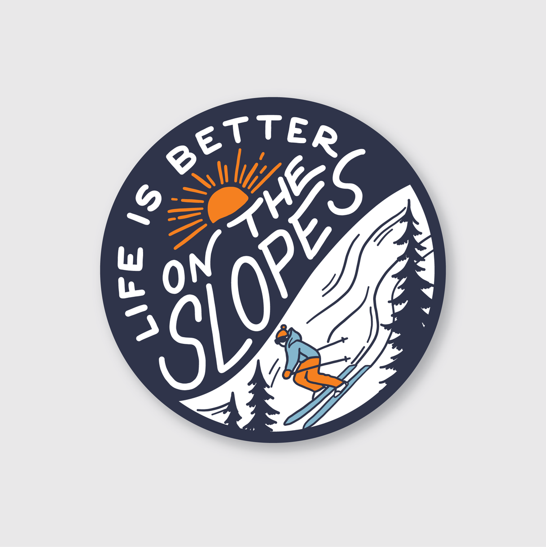 The "On The Slopes Sticker" by Pike Street Press is a die-cut vinyl sticker designed with durability in mind. It features a striking round blue and white illustration of a skier. Made from high-quality vinyl, it's weather-resistant, making it ideal for outdoor activities.