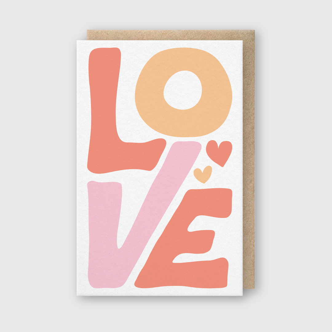 The Love Abstract Letters Greeting Card is a handcrafted piece from Seattle that artfully displays "LOVE" in bold, abstract letters. With the "L" and "E" in pink, the "O" in orange, and the "V" in peach, each letter features two small heart accents. The design is set against a light gray background, creating a vibrant expression of affection.