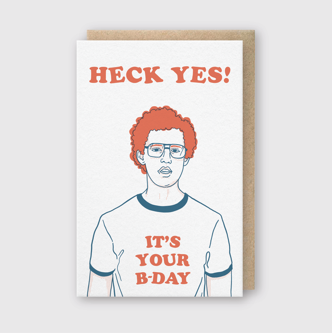 The "Heck Yes Birthday Card" features a playful design with a curly-haired character sporting glasses and a T-shirt declaring "IT'S YOUR B-DAY." The card stands out with bold "HECK YES!" lettering on a clean white background and comes with an eco-friendly recycled kraft envelope.