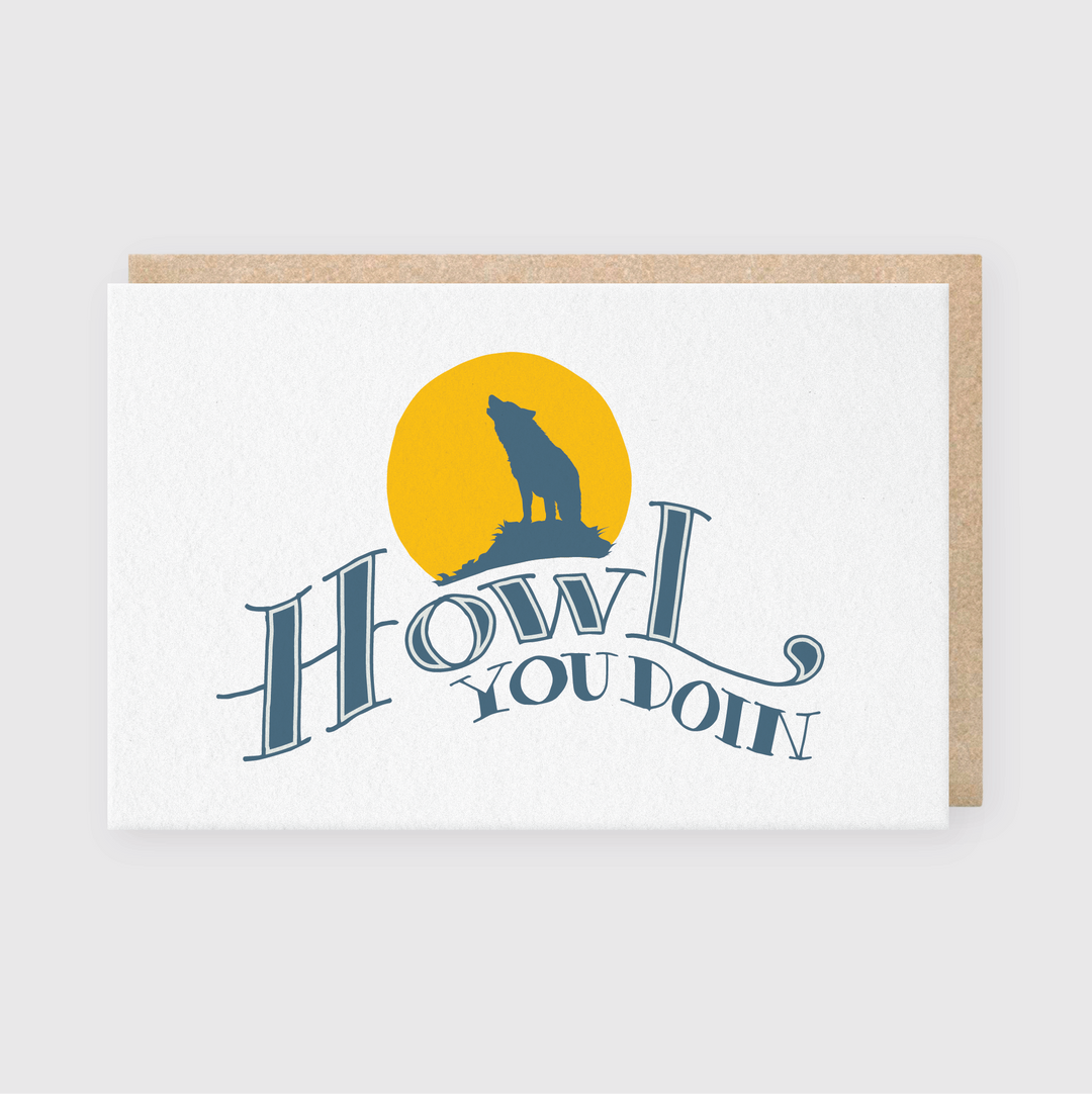 Pike Street Press offers the 'Howl You Doin' Greeting Card, featuring a handcrafted design with a humorous silhouette of a howling wolf set against a yellow moon-like circle. The card's crisp white background is complemented by stylized blue text, adding an extra touch of charm.