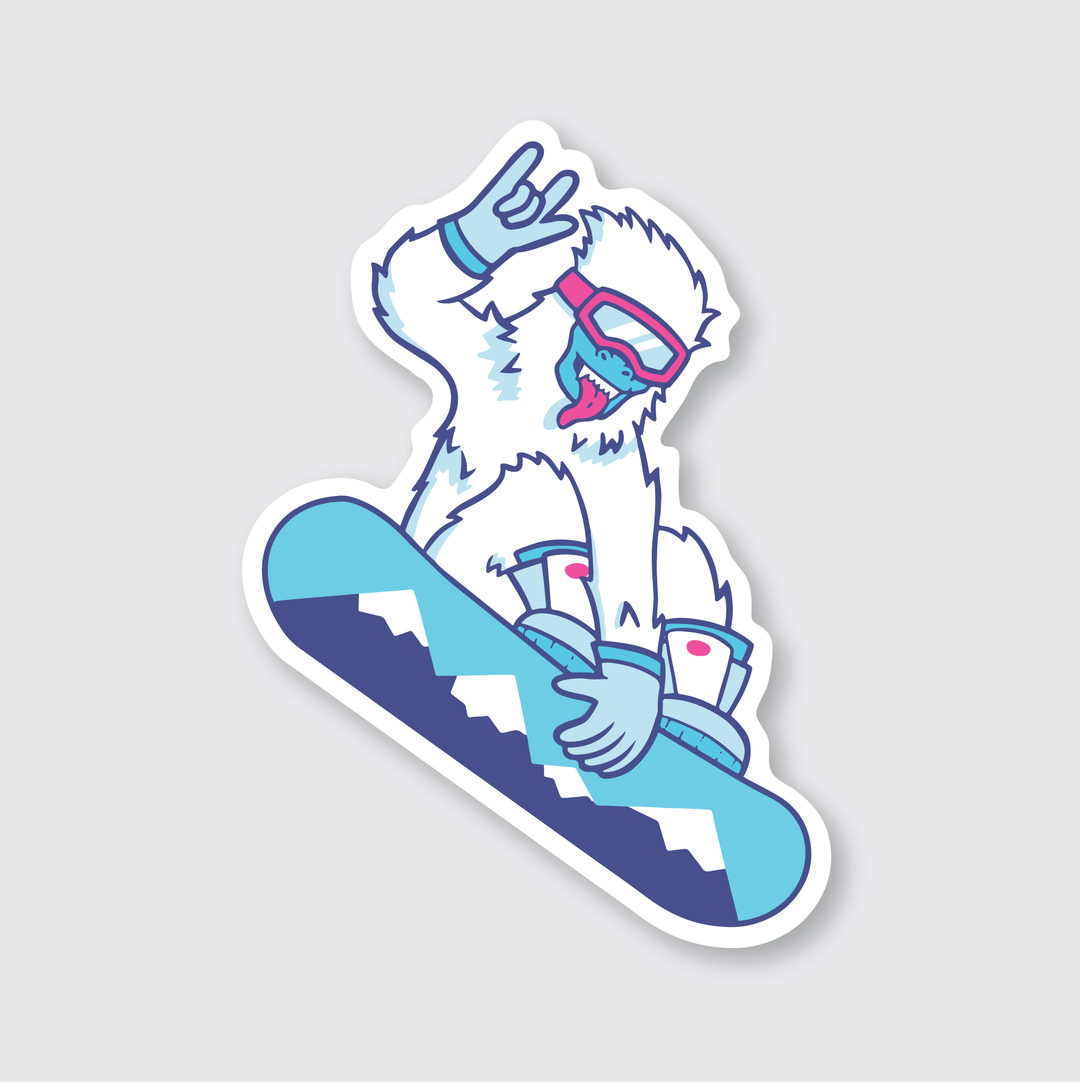 Introducing the Shreddy Yeti Sticker: a die-cut vinyl sticker featuring a cartoon yeti snowboarding on a blue board. The fun-loving yeti, with pink goggles, makes a playful hand sign while gliding through snow-capped mountain designs. This outdoor-rated sticker is set against a sleek gray background.