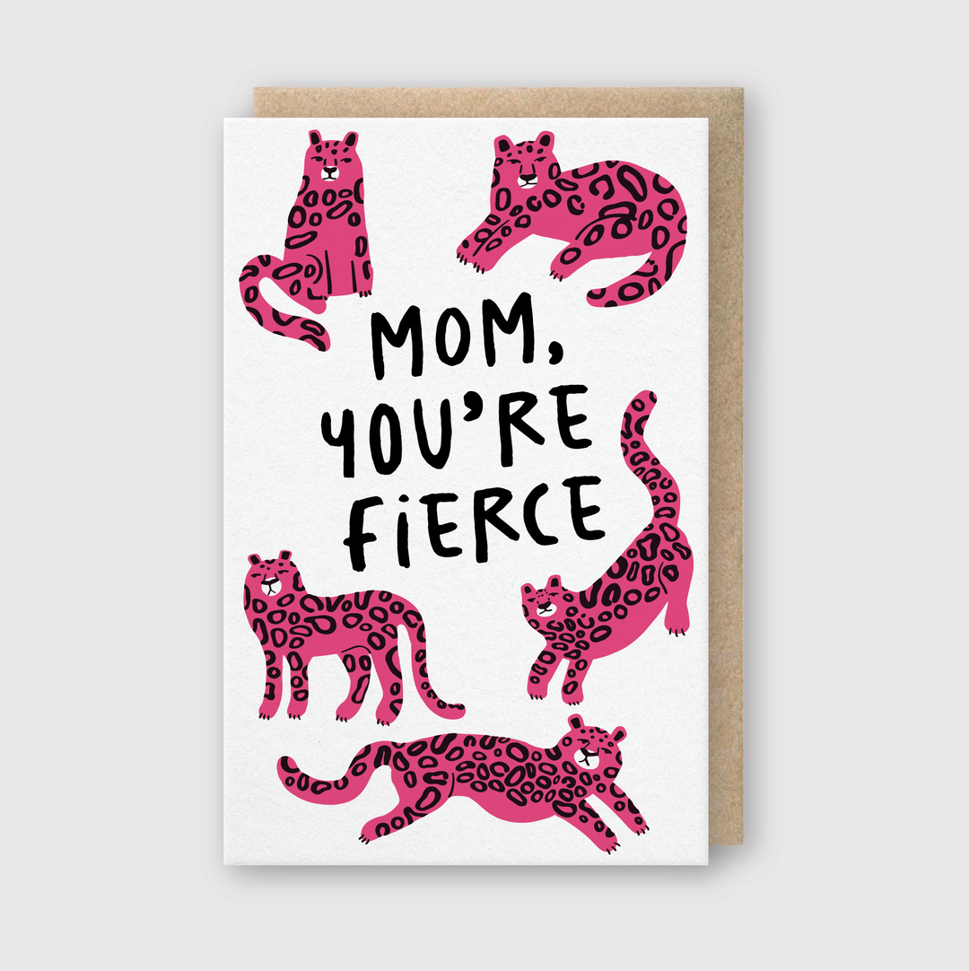 The "Mom, You're Fierce" Greeting Card is a high-quality letterpress design featuring five pink leopards in playful poses around the message "MOM, YOU'RE FIERCE" on a white background. This handmade card comes with a stylish brown envelope, making it perfect for expressing admiration.
