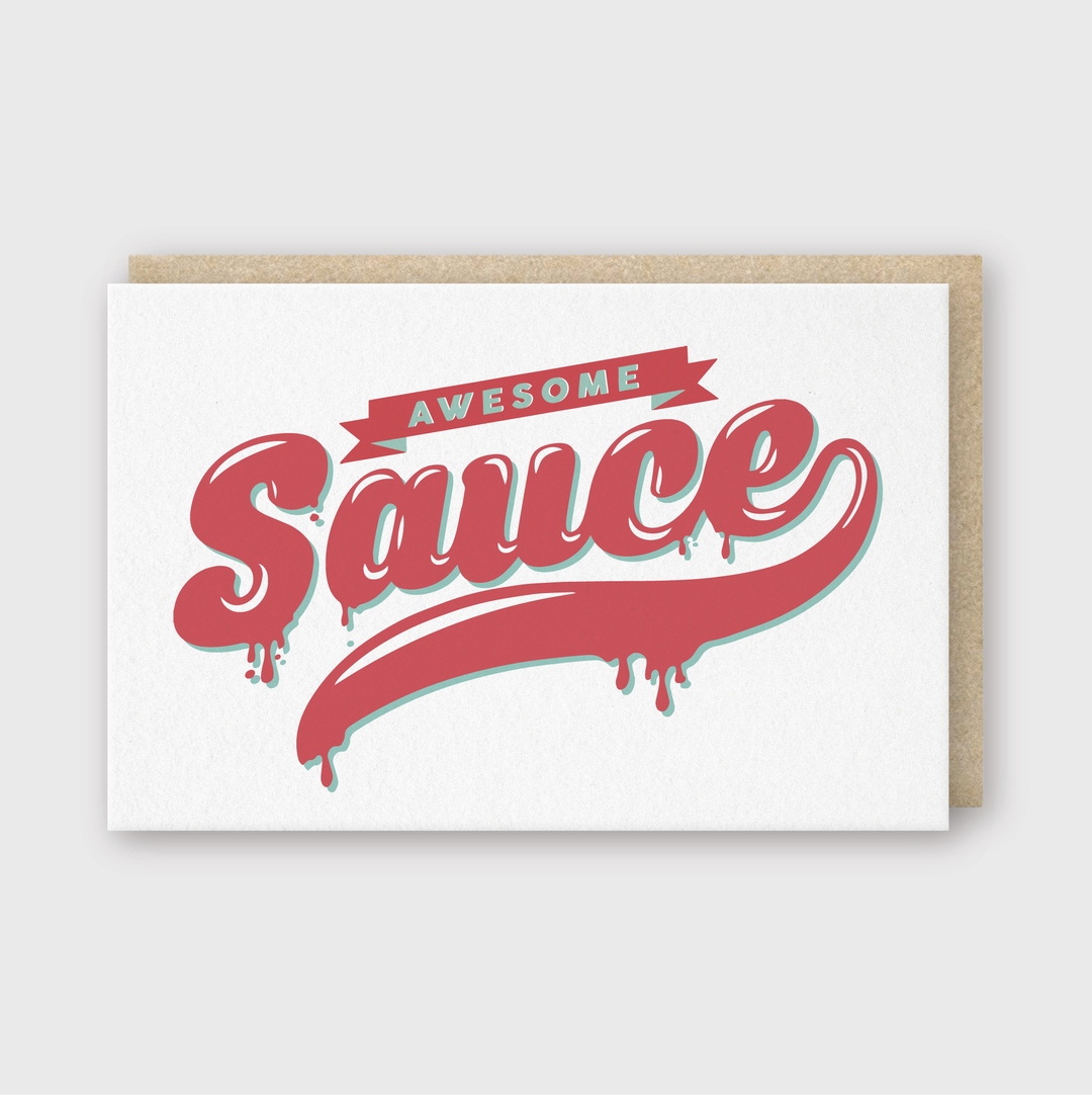 The Awesome Sauce Greeting Card features the phrase "Awesome Sauce" in bold, stylized letters with drippy ends. It's designed against a crisp white background and includes a subtle light gray border. The card is complemented by a classic brown envelope.