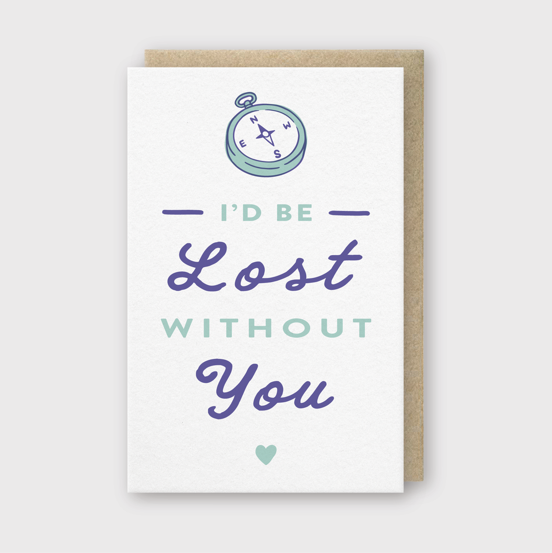 The "Lost Without You Card" from Pike Street Press features a compass design alongside the heartfelt message, "I’d be lost without you," in shades of purple and teal. This card is hand-printed in Seattle using environmentally friendly soy-based inks. It is finished with a small heart symbol at the bottom and comes with a brown envelope.