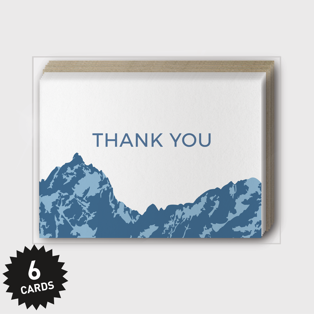 This set of "Thank You" Mountains Blue Greeting Cards features a blue silhouette of mountain peaks on the cover. Handcrafted in Seattle, the box set includes 6 cards.