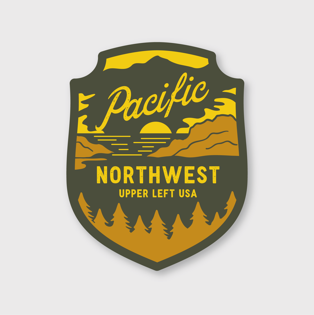Introducing the PNW Forest Badge Sticker, a vibrant and high-quality emblem featuring the text "Pacific Northwest Upper Left USA." This sticker showcases a stunning sunset over mountains with silhouettes of trees in shades of green, yellow, and orange. It's perfect for enhancing your branding needs.