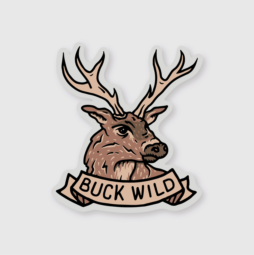The Buck Wild Sticker exhibits a deer with antlers, complemented by a ribbon beneath bearing the words "BUCK WILD." The design is enhanced by soft shadows on a light gray backdrop, adding an adventurous and sticker-like appeal.