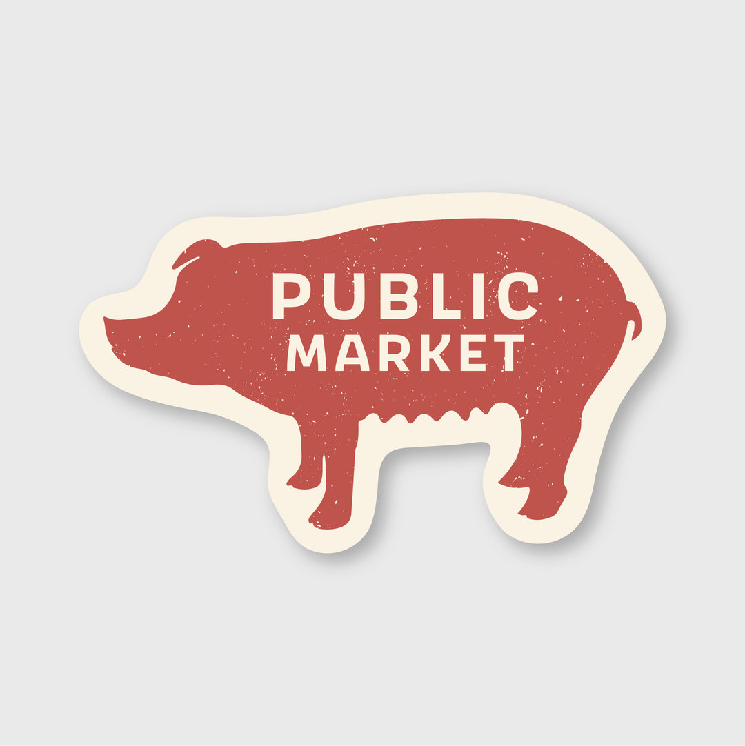 Introducing the Market Pig Sticker: a red, die-cut vinyl sticker shaped like a pig. It showcases "PUBLIC MARKET" in bold white letters with a rustic, textured finish. The sticker is outlined in white against a light gray background and is designed to be water and weather resistant for long-lasting durability.