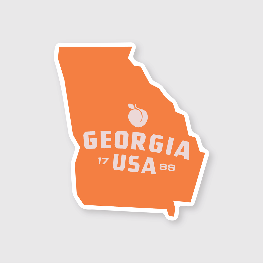 The Georgia Simple State Sticker features an orange silhouette of the state, highlighted by a peach icon at the top. The words "Georgia USA" are displayed prominently across the center in white block letters, with "17" and "88" on either side to represent the state's founding year. This sticker is crafted from premium die-cut vinyl, celebrating Georgia's rich heritage.