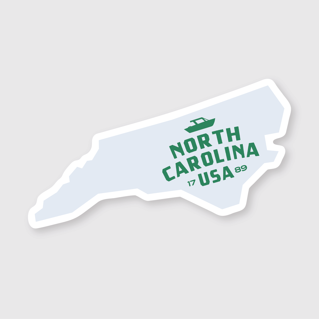 The North Carolina Simple State Sticker is a vinyl sticker shaped like North Carolina, featuring the text "North Carolina USA" in green letters. It is weather resistant and artistically designed, making it perfect for displaying state pride with both durability and style.
