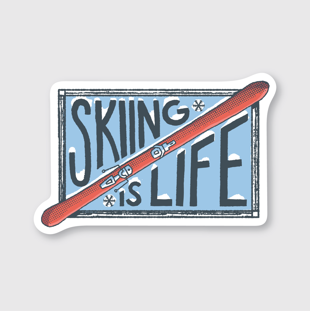 Introducing the Skiing Is Life Sticker: This vinyl sticker features the phrase "Skiing is Life" in bold letters, with a red ski diagonally crossing over the text and small snowflakes scattered around. The durable outdoor-rated design is set against a light blue square with a white border, making it perfect for displaying your love for skiing.