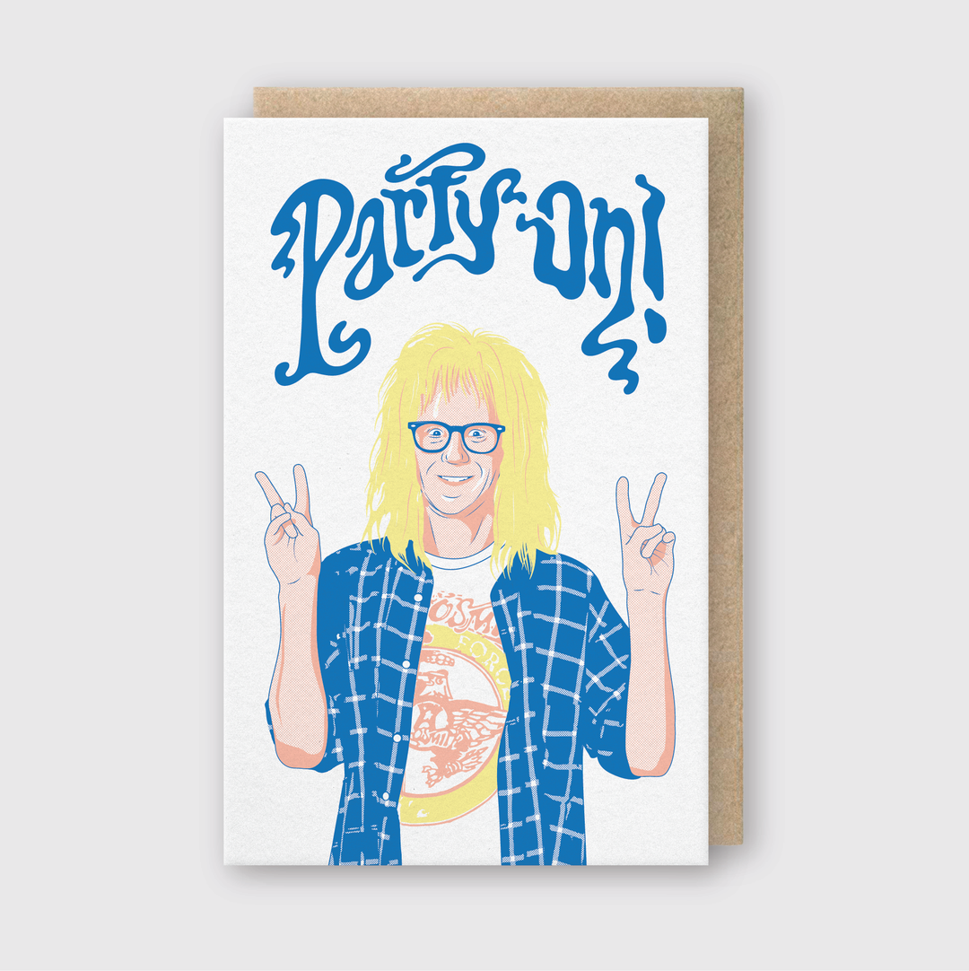 The "Party On!" greeting card by Pike Street Press features an illustration of a smiling person with long blond hair, glasses, and a checkered shirt over a t-shirt, flashing peace signs. The words "Party On!" are prominently displayed in bold blue letters above the image. This handcrafted card is made in Seattle using FSC Certified Paper and includes a brown envelope.