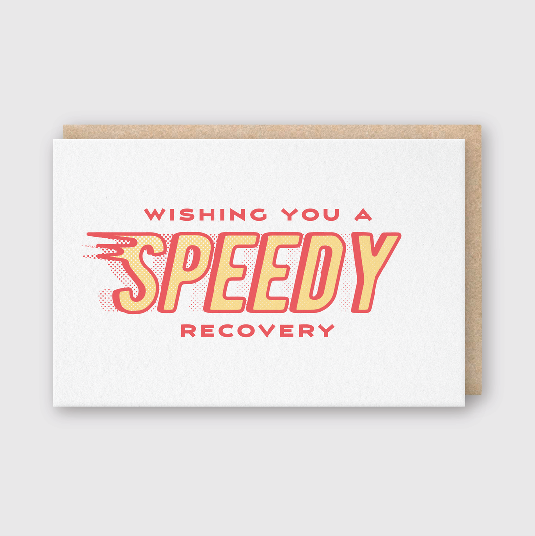 Introducing the Speedy Recovery Greeting Card, featuring the bold message "Wishing You a Speedy Recovery" in vibrant red and yellow text. The dynamic design emphasizes "Speedy," giving it a sense of motion. This handcrafted card is made in Seattle using FSC Certified Paper and includes a brown envelope, all set against a plain white background.