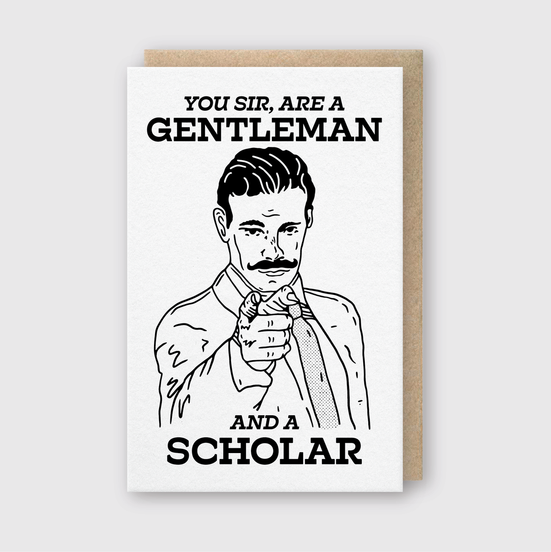 The You Sir Gentleman & Scholar Greeting Card features an illustration of a mustached man pointing forward with the text "You sir, are a gentleman" above and "and a scholar" below. It is handcrafted in Seattle on FSC Certified Paper and includes an elegant brown border.