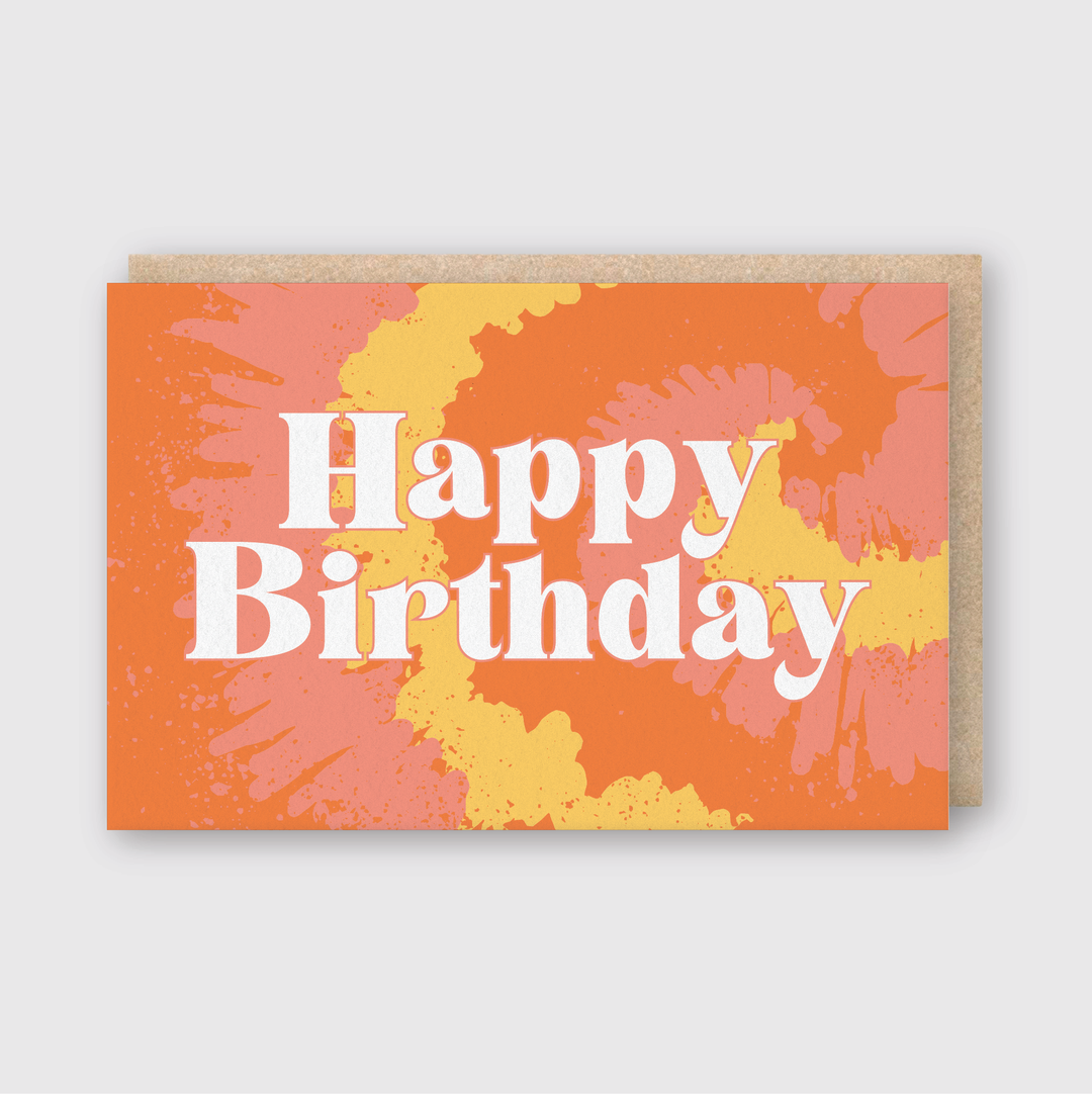 The Happy Birthday Tie Dye card features bold white letterpress text on a lively orange background with pink and yellow tie-dye patterns. It comes with a recycled kraft envelope, making it a memorable choice for any birthday celebration.