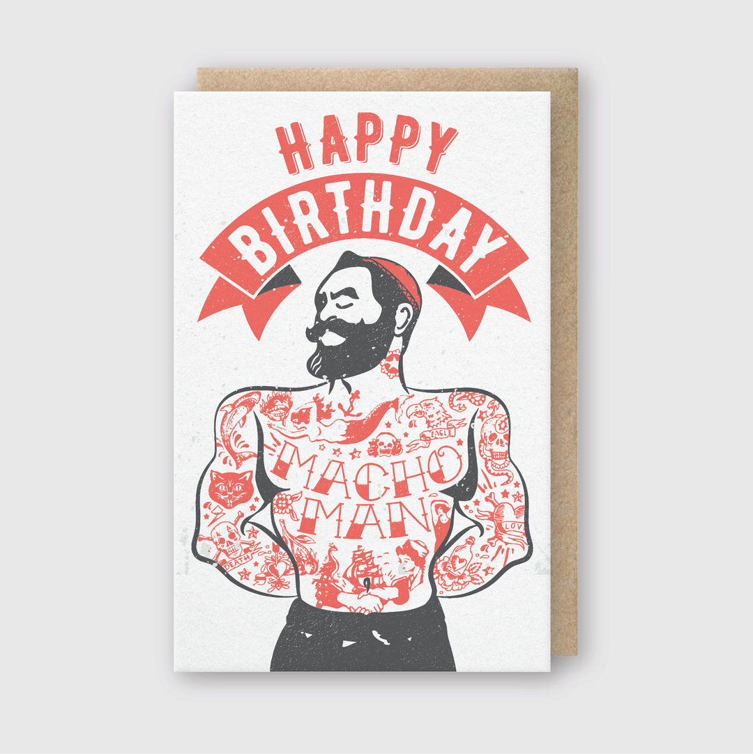 The Macho Man Greeting Card is a handcrafted item made from FSC certified paper. It showcases an illustration of a muscular man with tattoos, a beard, and a handlebar mustache. The phrase "HAPPY BIRTHDAY" is boldly printed in red and black on the white background, with "MACHO MAN" tattooed on his chest.