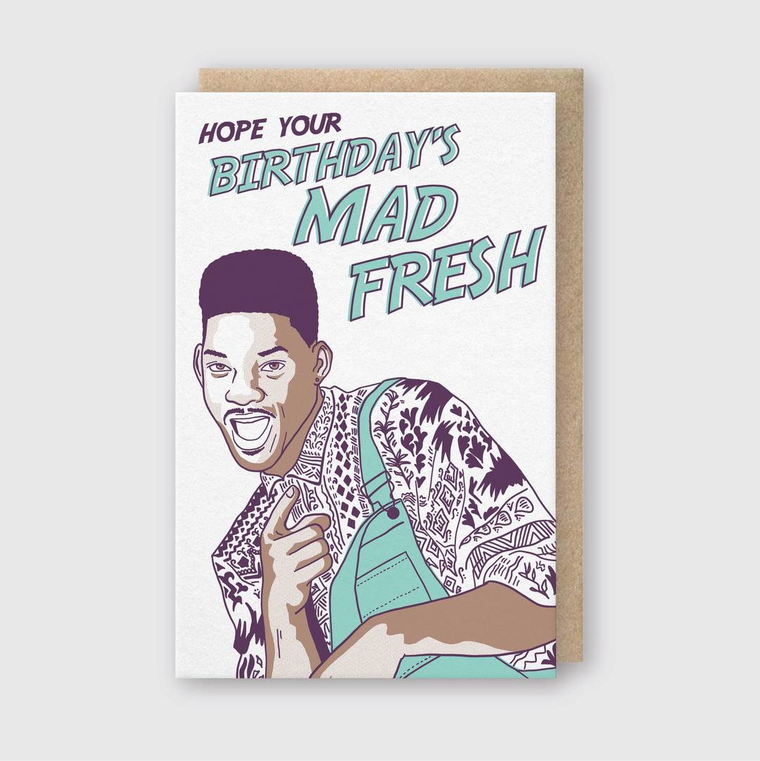 Introducing the Mad Fresh Birthday card: This vibrant greeting card features a retro-themed illustration of a grinning person playfully pointing, accompanied by bold text declaring, "Hope your birthday's mad fresh," set against a subtle light gray background. It includes an eco-friendly hand-printed recycled kraft envelope.