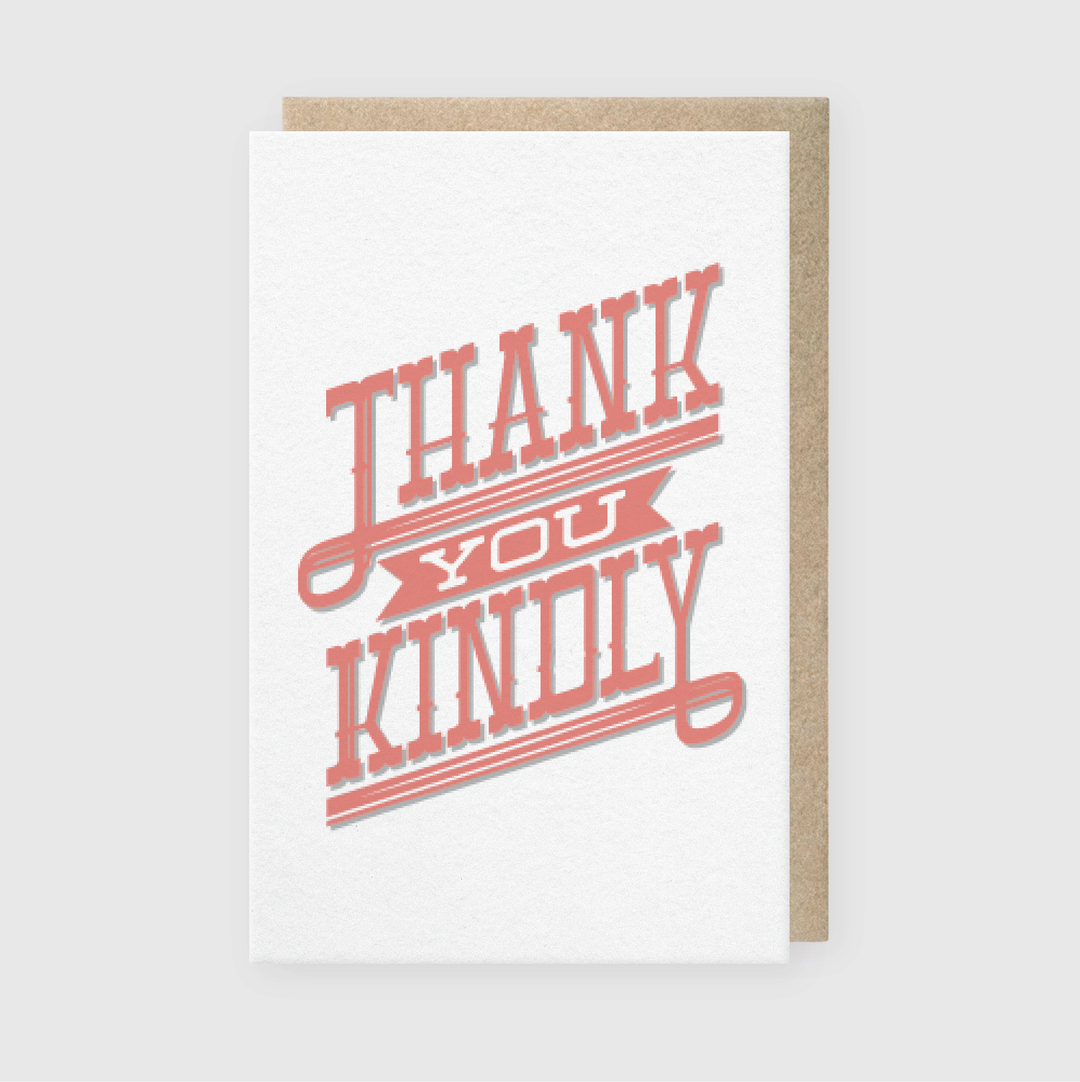 The Thank You Kindly Type Card Greeting Card features a premium letterpress design with pink, stylized text reading "Thank You Kindly" against a white background and has a distinctive kraft paper backing.