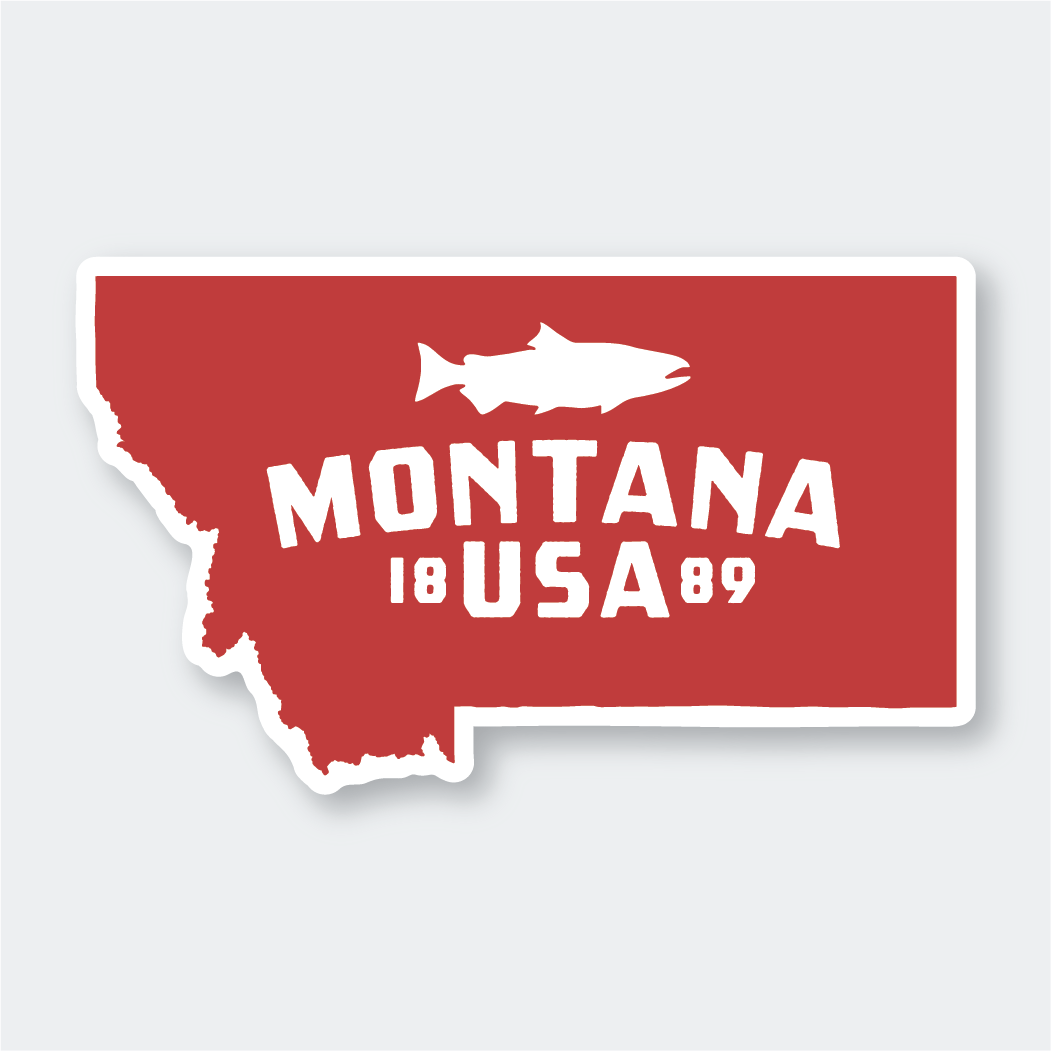 The Montana Red Sticker is a vibrant vinyl decal featuring a red silhouette of the state with a white outline. Inside this silhouette, there's a white fish icon above the bold text "Montana USA 1889." This die-cut vinyl sticker is perfect for showcasing state pride with style.