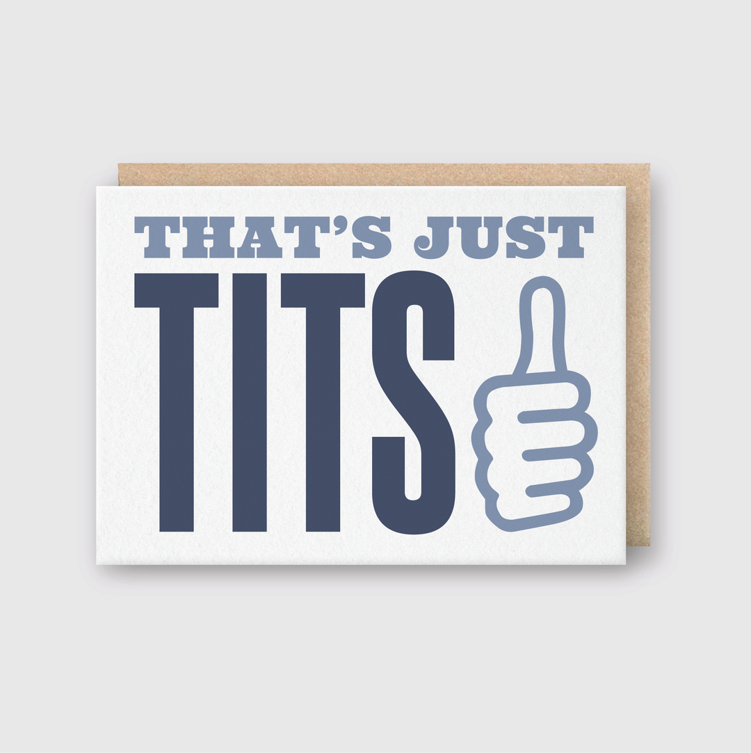 The "That's Just Tits Greeting Card" features bold, blue text with a thumbs-up illustration on a light gray background, adding a whimsical touch to your card collection.