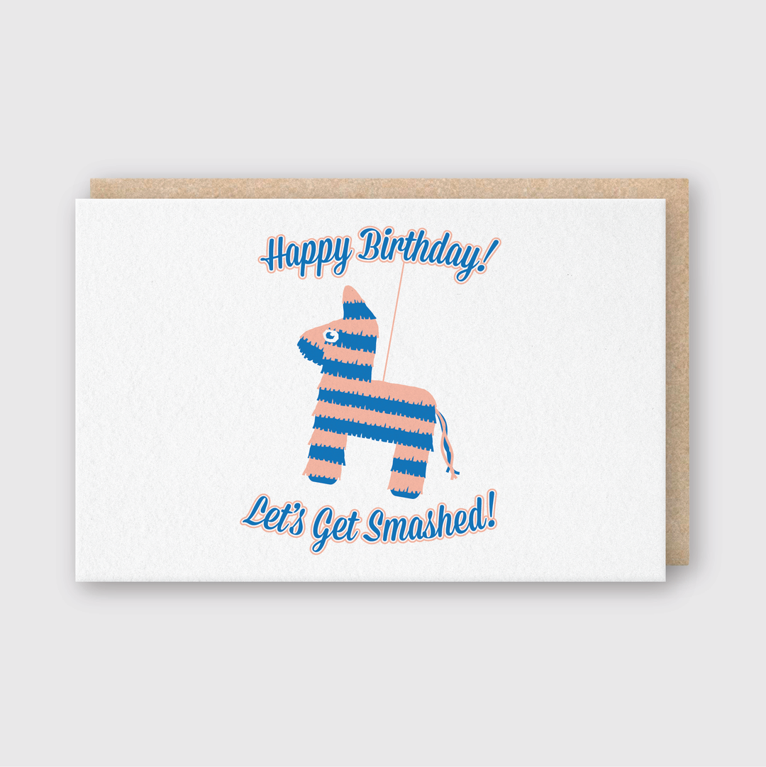 The Let's Get Smashed card features a vibrant, striped piñata illustration with "Happy Birthday!" on top and "Let's Get Smashed!" underneath. This quality letterpress design is perfect for birthday celebrations and comes with a light brown envelope.