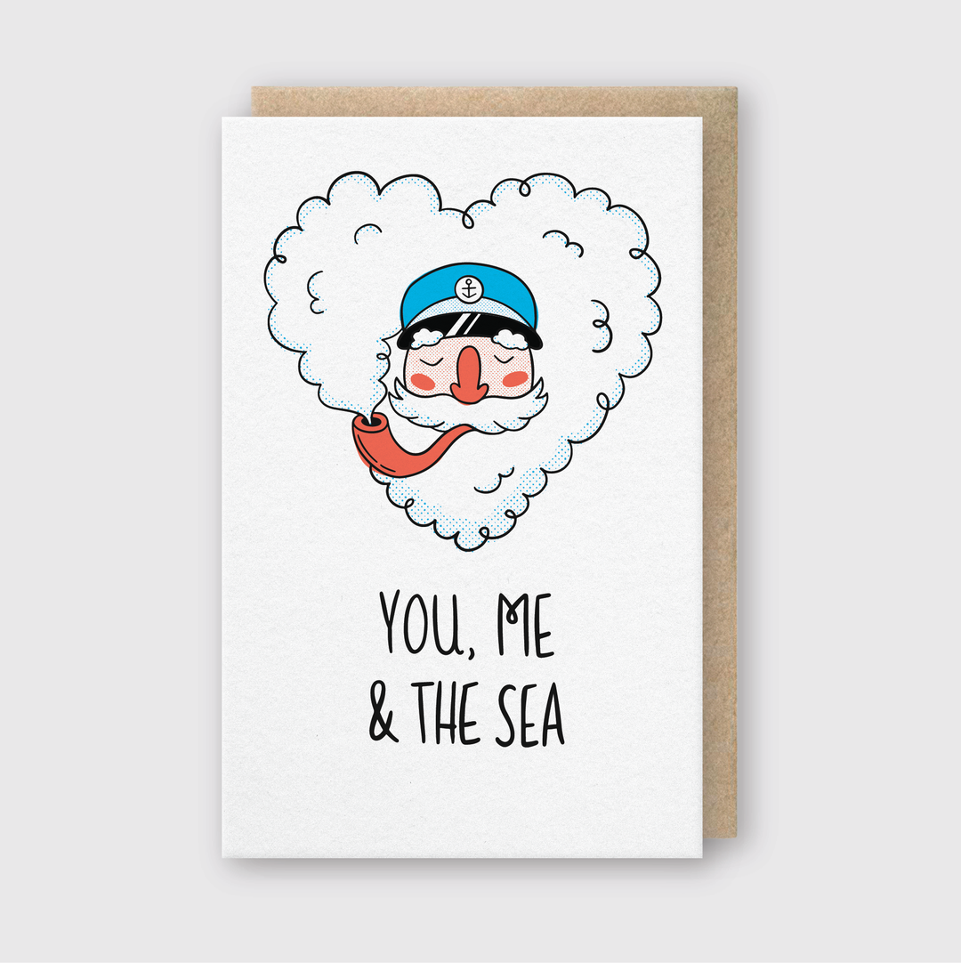 Introducing the "You Me and the Sea" greeting card, a delightful homage to ocean enthusiasts. Showcasing a cheerful sailor in a blue cap encircled by a heart-shaped cloud, this card is meticulously handcrafted in Seattle to beautifully convey seaside affection.