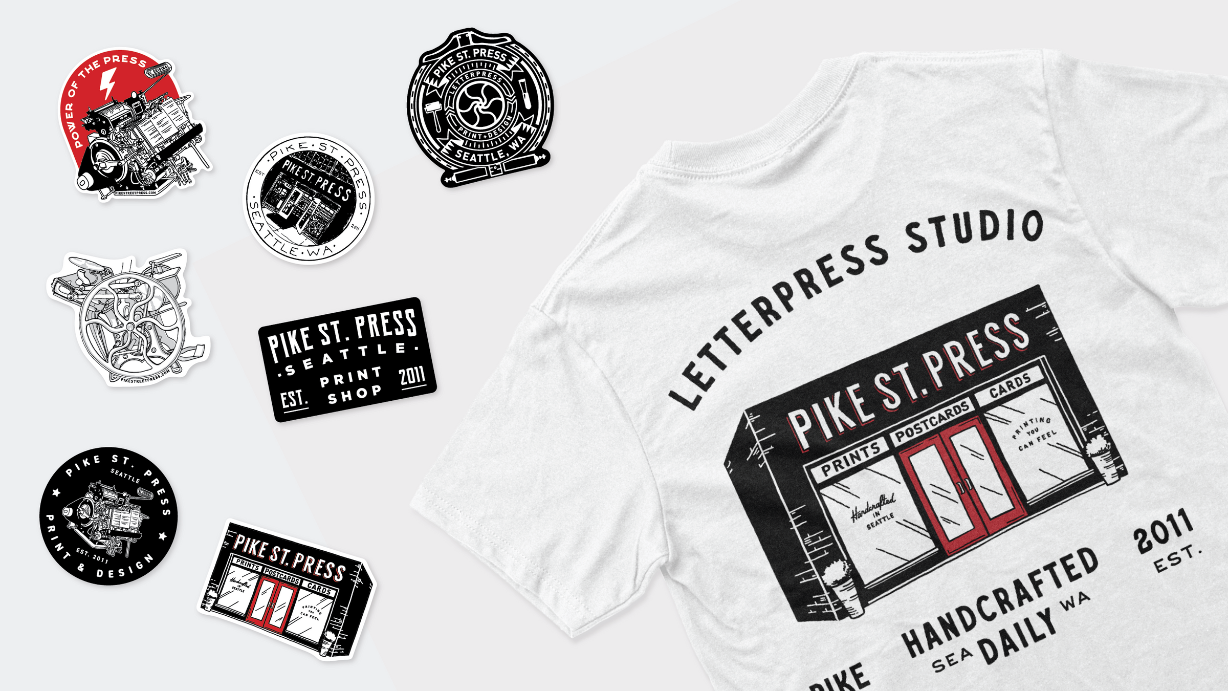 A white T-shirt featuring a unique design is surrounded by stickers showcasing "Letterpress Studio" graphics. The collection includes images such as a typewriter, a car, and other creative illustrations.