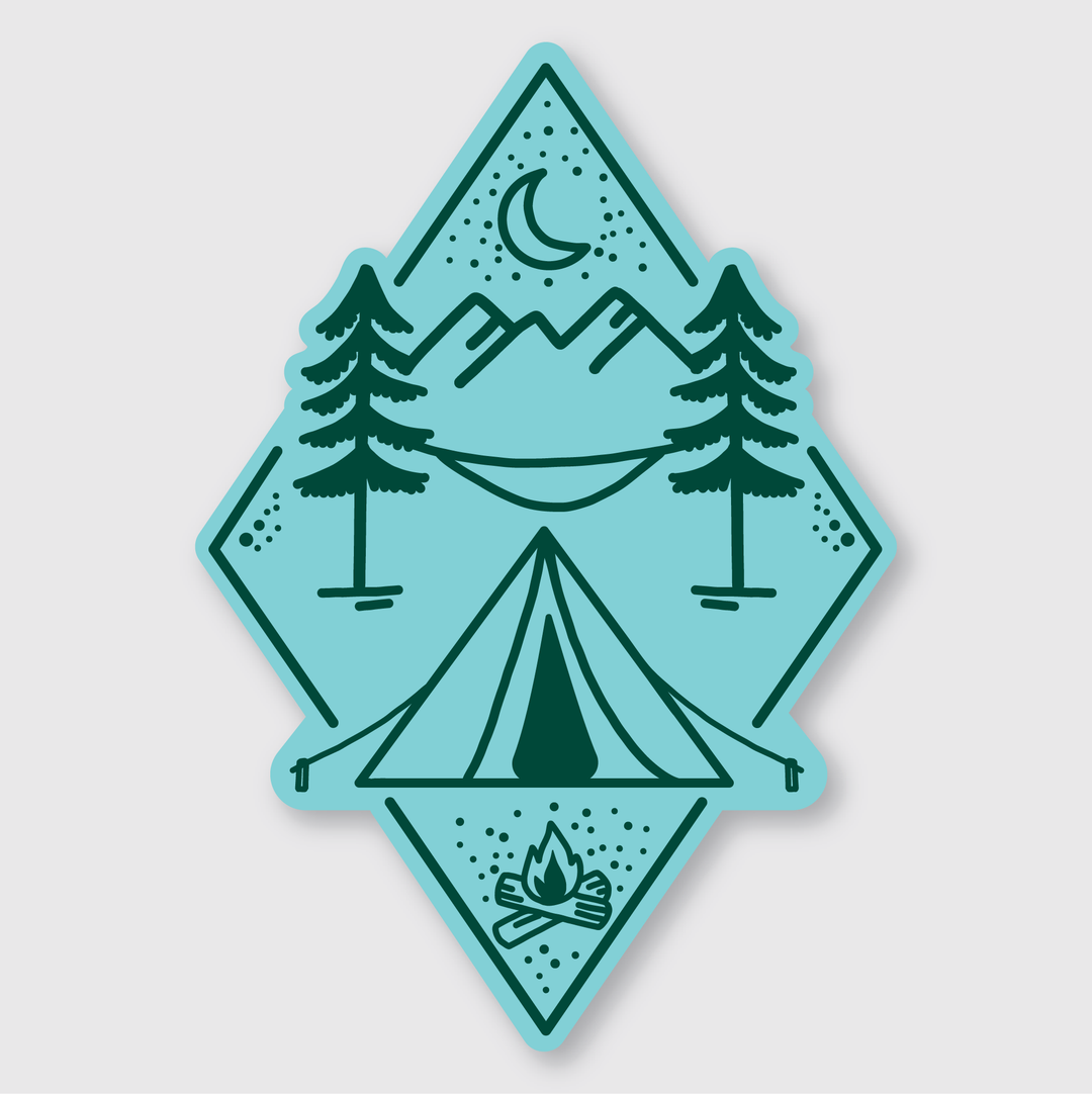 The Campsite Sticker is a beautifully stylized illustration depicting a serene camping scene. It features a tent, campfire, and two pine trees, with a hammock swinging between the trees beneath majestic mountains and a crescent moon. All these elements are elegantly framed within a diamond shape. Made from die-cut vinyl, this sticker is perfect for those who appreciate the tranquility of nature.