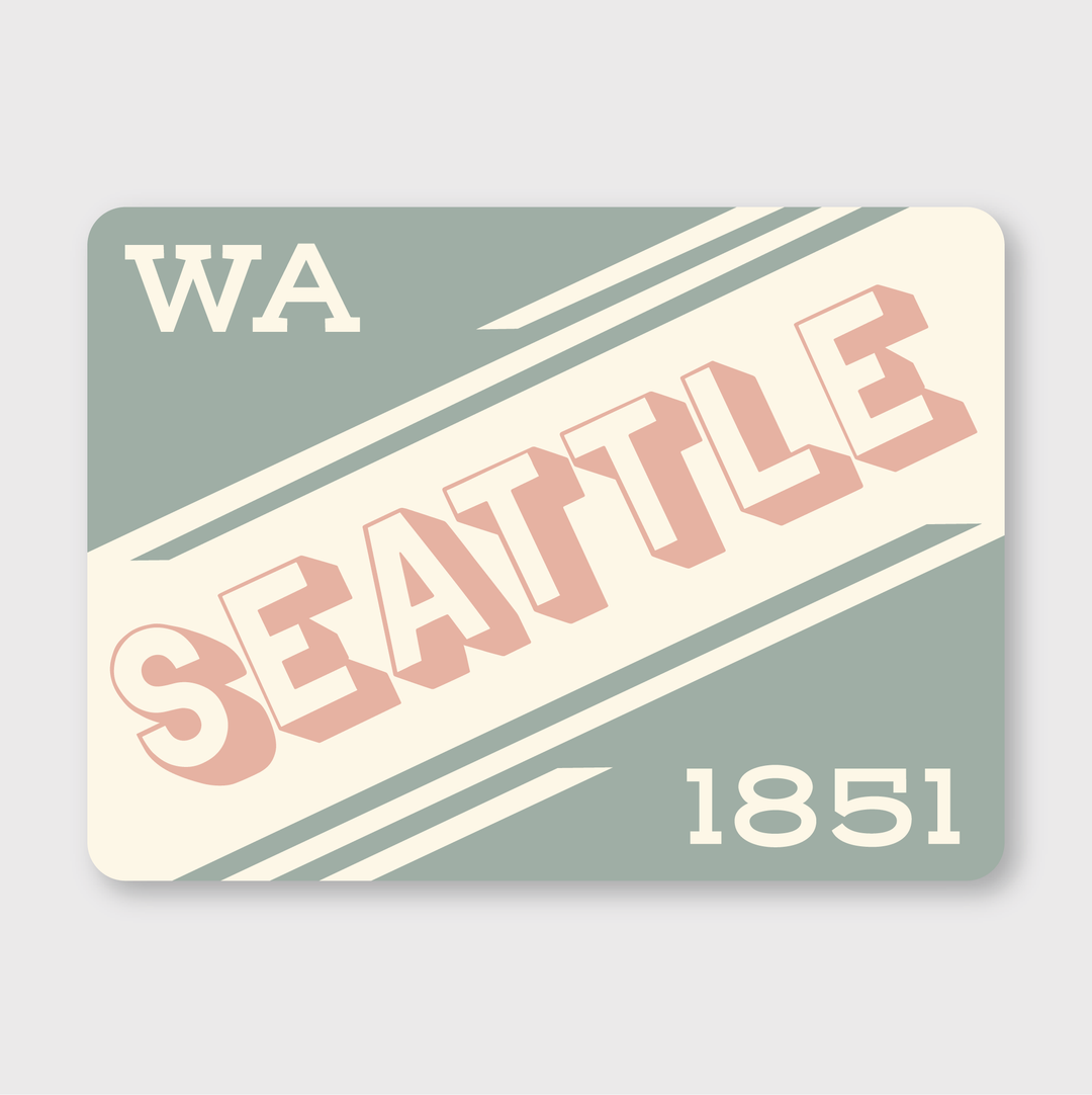 This Seattle Retro Type Sticker features a vintage postcard design with the word "Seattle" in bold pink and white letters set diagonally across a greenish-grey backdrop. The sticker also includes "WA" in the top left corner and "1851" in the bottom right. Made from vinyl, it is durable, water, and weather-resistant.