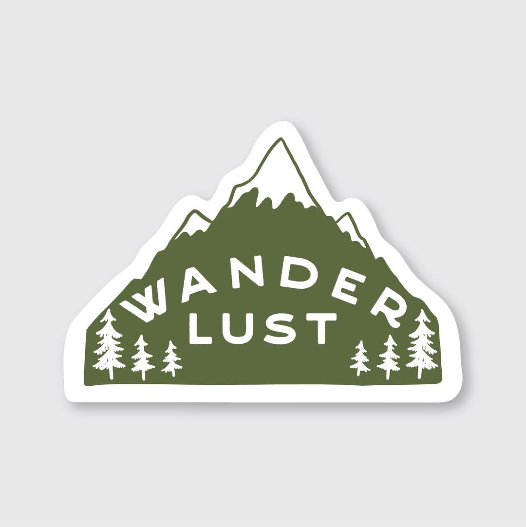 Introducing the Wanderlust Sticker from Pike Street Press: This mountain-shaped vinyl sticker comes in a striking green color and is adorned with "Wanderlust" in bold white letters. It features small pine tree illustrations set against a light gray background. The sticker is weather-resistant and artistically designed, making it an ideal companion for your adventures.