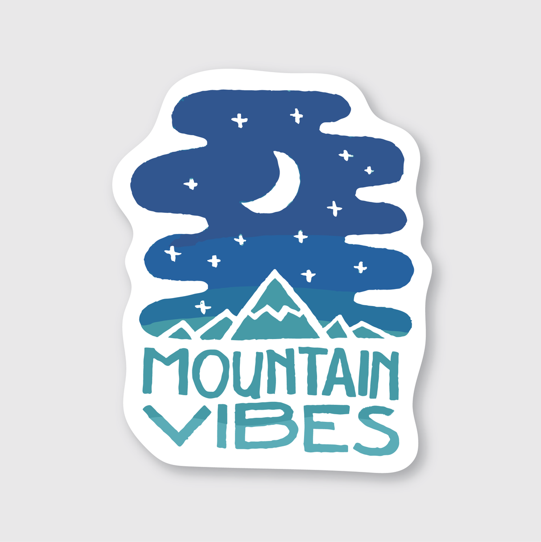 The "Mountain Vibes Sticker" showcases a crescent moon and stars above stylized mountains, designed by skilled artists. The phrase "Mountain Vibes" is prominently displayed in bold, blue lettering. This die-cut vinyl sticker features a crisp white background and is both water and weather resistant.