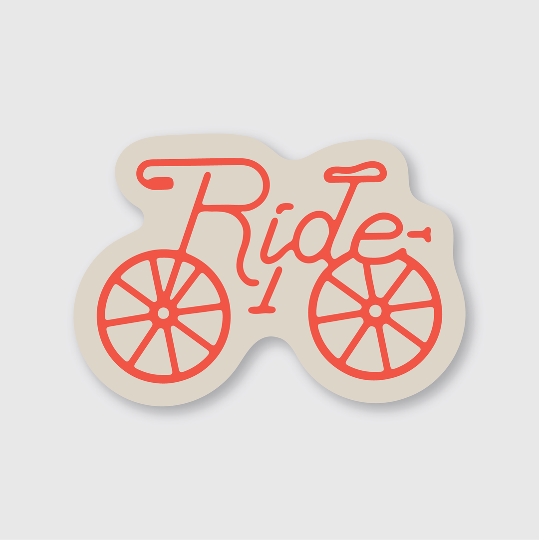 This bicycle-themed sticker showcases the word "Ride" in red script, creatively forming a stylized bicycle with wheels. The vibrant design is set against a light beige background, offering a playful and unique aesthetic.