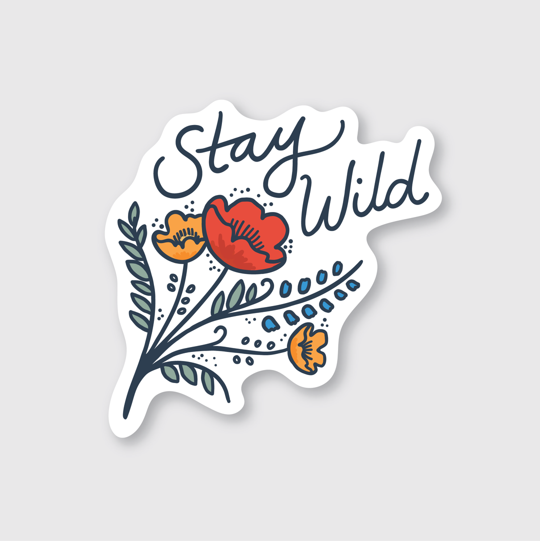 The Stay Wild Wildflowers Sticker showcases the phrase "Stay Wild" in cursive, complemented by vibrant illustrated wildflowers in red and orange hues along with lush green leaves. Designed with an artistic touch, it features a white, irregularly shaped background that enhances its creative appeal.