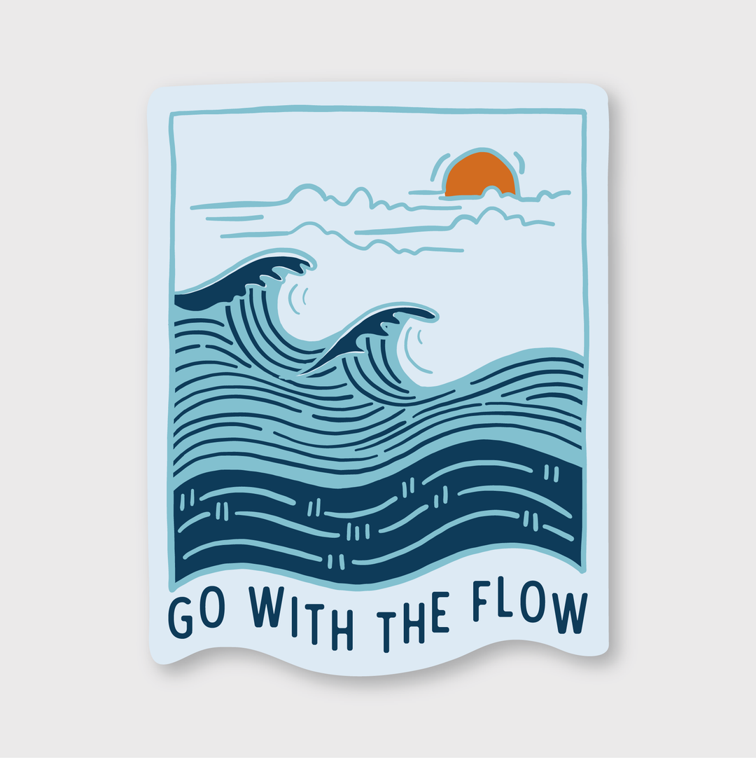 The "Go With The Flow" sticker features a stylized illustration of ocean waves, a setting sun, and clouds. The phrase "GO WITH THE FLOW" is displayed beneath the image. This handcrafted die-cut vinyl sticker highlights blue and orange hues on a white background and is made to ensure quality and uniqueness.