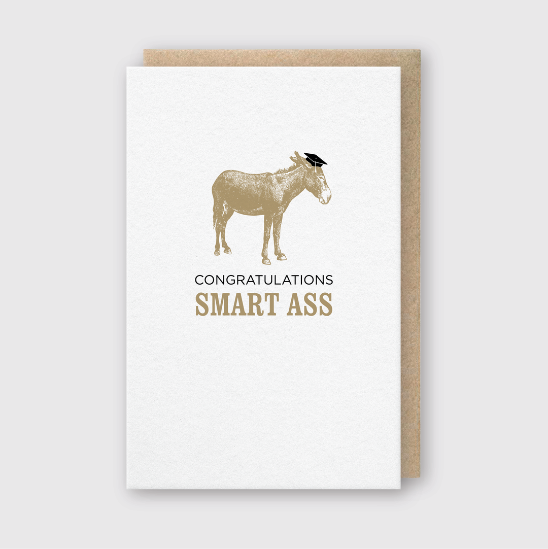 The Congrats Smart Ass Greeting Card features a donkey with a graduation cap and the message "Congratulations Smart Ass." It's a fun way to celebrate academic achievements with humor.