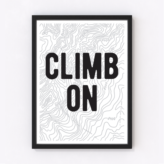Bold black letters over gray topographic contour lines, presented in a beautifully crafted and framed art print.