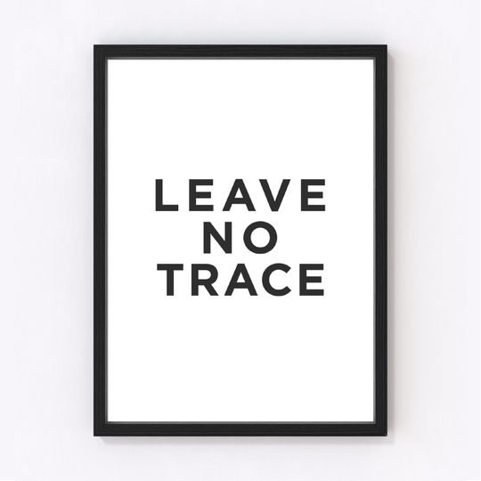 A minimalist art print with bold black capital lettering on a crisp white background, presented in a decorative frame.