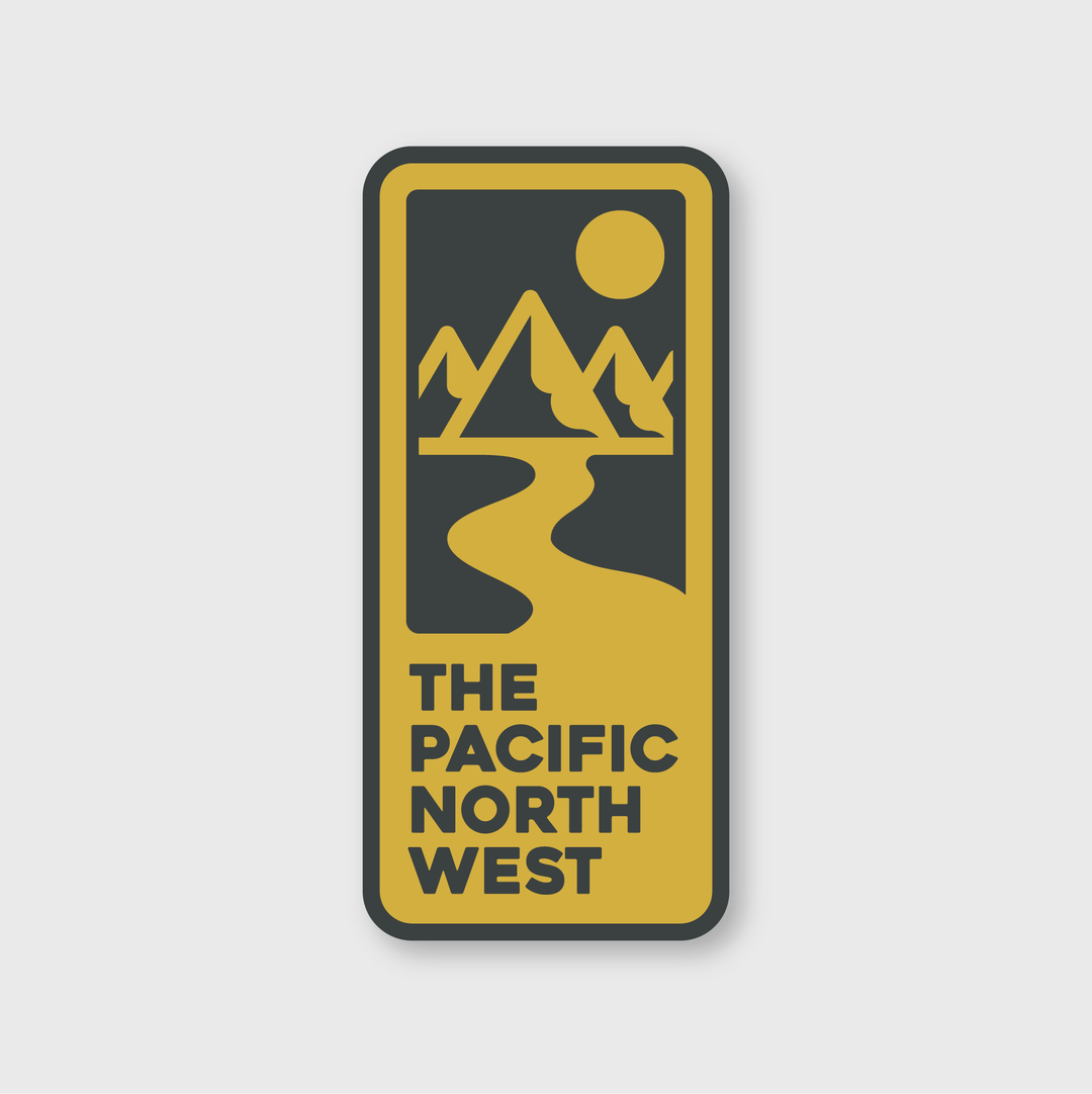 Sticker features a custom yellow river flowing from stylized mountains under a sun, all within a rectangle. Below is "The Pacific North West" text. Evocative of Seattle's natural charm, the design appears against a gray background with a black border, making it an ideal choice for unique stickers. Product Name: PNW Retro Sign Sticker by Pike Street Press.