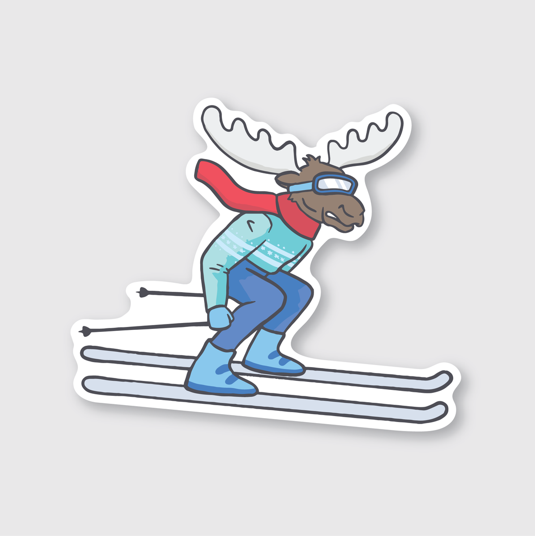 Presenting the Ski Moose Sticker: a die-cut vinyl showcasing a cartoon moose skiing down a slope in blue ski gear, complete with goggles and a red scarf. Its antlers stand out against the crisp white background in this weather-resistant design, making it ideal for any adventurous spirit.